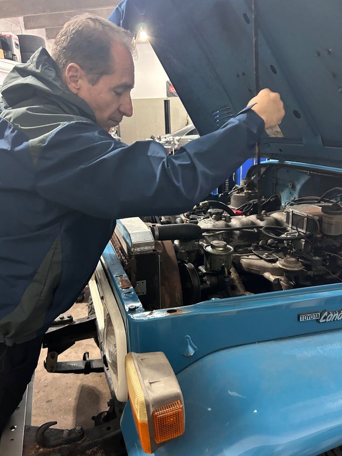 Luciano Cappelli working on a classic Toyota Land Cruiser engine at Cappelli and Son Automotive
